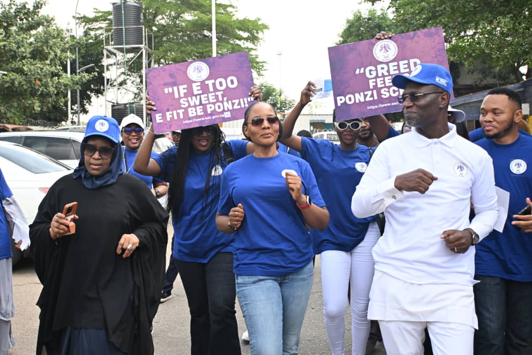 SEC officials marching with anti-Ponzi signs